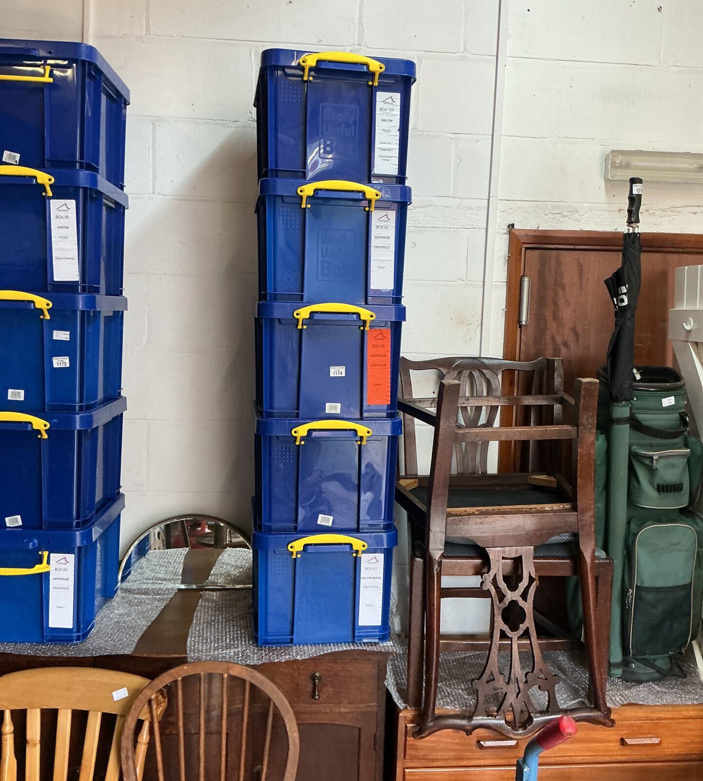 Stack of five blue plastic storage containers for organizing.