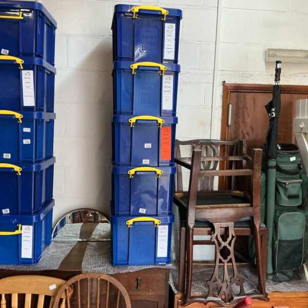 Stack of five blue plastic storage containers for organizing.