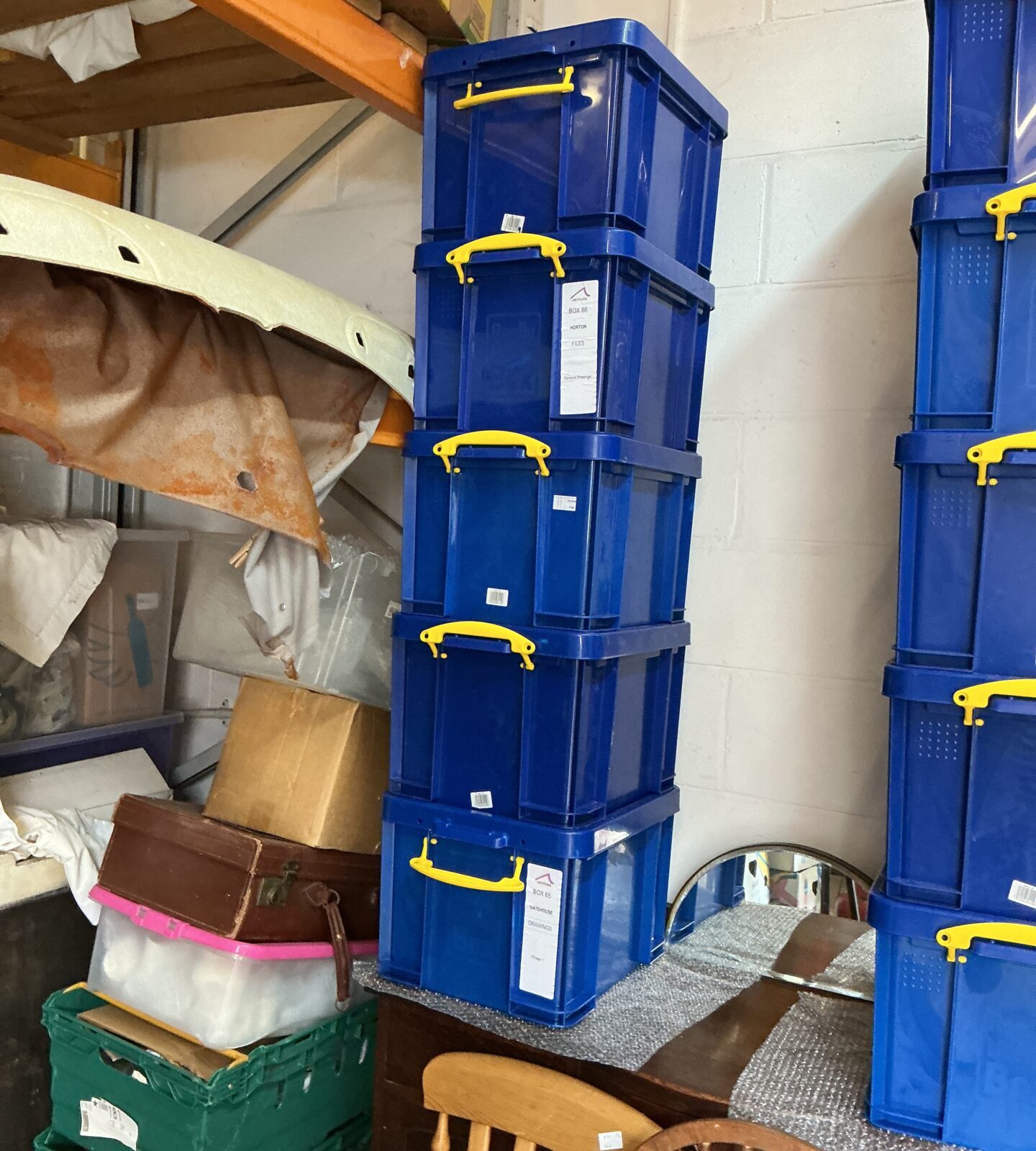 Stack of five blue plastic storage containers for organisation.