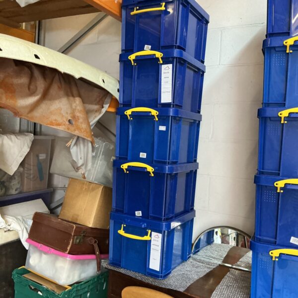 Stack of five blue plastic storage containers for organisation.