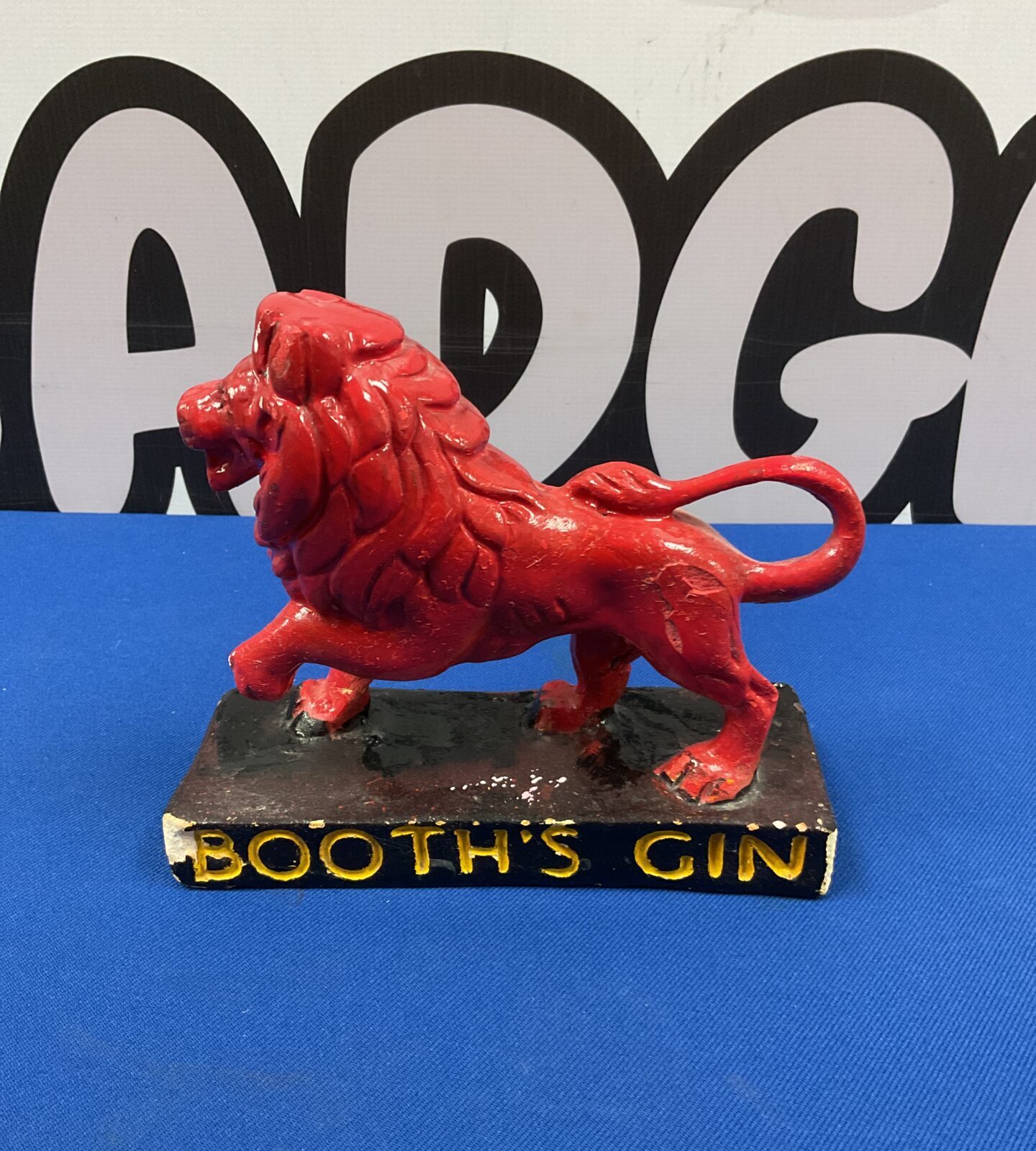 Side view of vintage Booth's Gin chalkware lion statue.