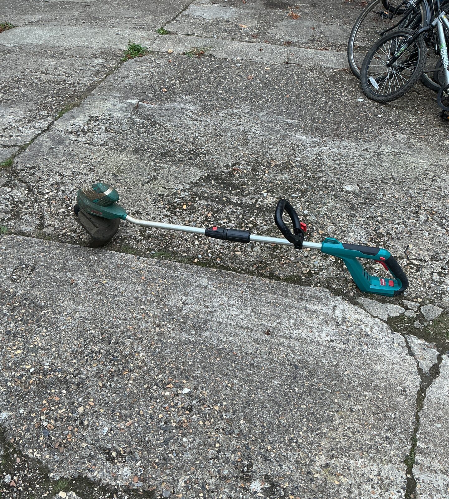 Bosch cordless strimmer for garden edging and weed control.
