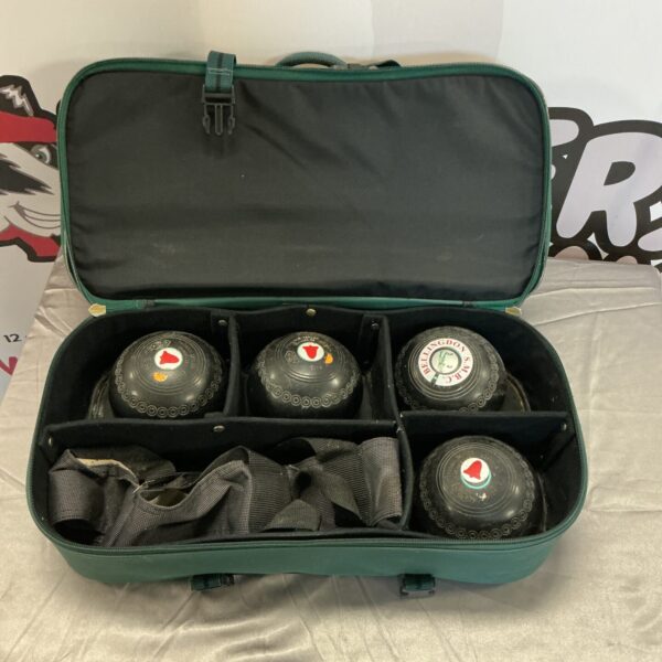 Open green bowling bag displaying four colourful bowling balls.
