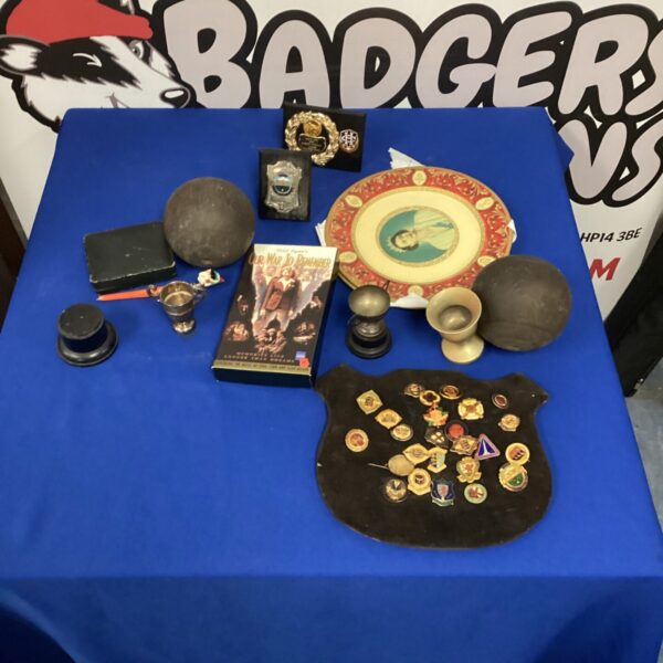 Vintage box bowling memorabilia lot including badges and trophies.