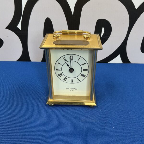 Elegant brass carriage clock by Wm Widdop with Roman numerals.