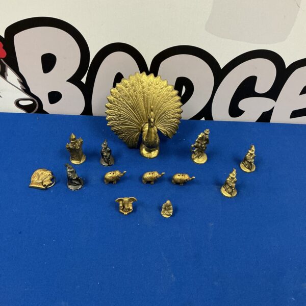 Vintage brass figurines collection featuring a peacock and miniature animals.
