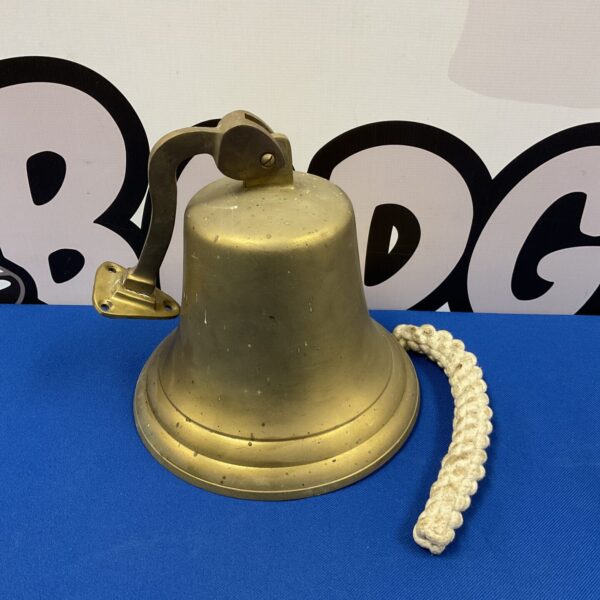 Vintage brass pub last orders bell with rope attached.