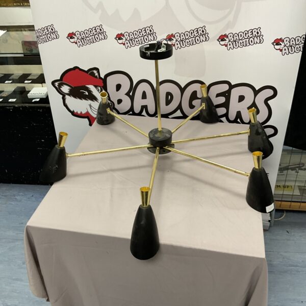 Vintage brass sunburst ceiling light with conical shades.