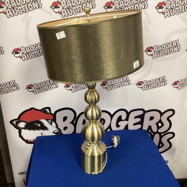 Vintage brass table lamp with shade, classic home decor.