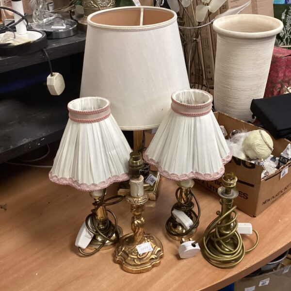 Lot of five vintage brass table lamps with cream shades.