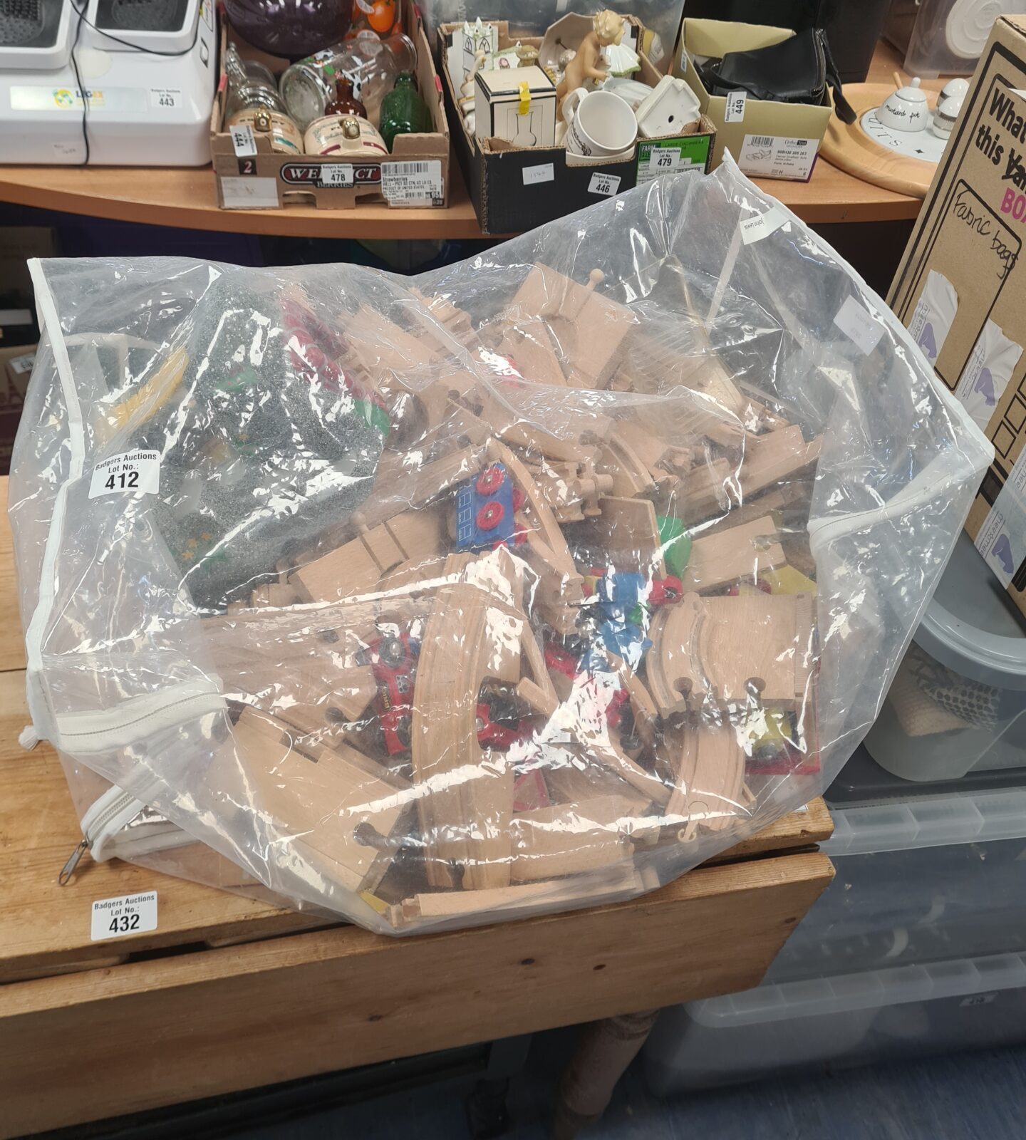 Bag of Brio train set tracks and wooden pieces.