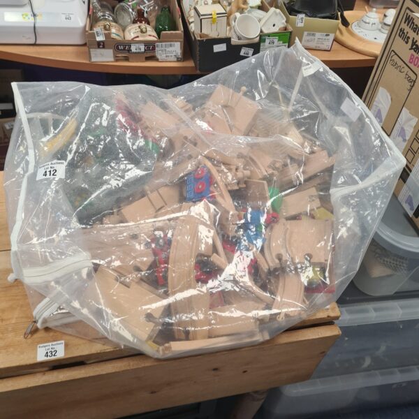 Bag of Brio train set tracks and wooden pieces.