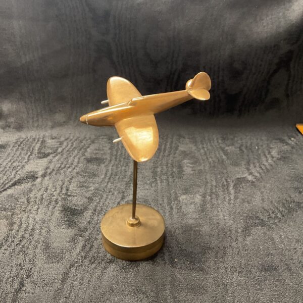 Detailed bronze Spitfire model on a circular base.