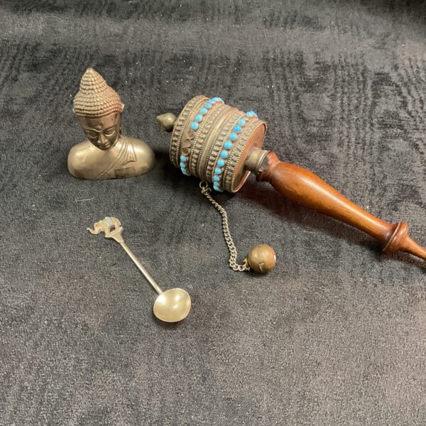 Antique Buddhist prayer wheel and spoon set, detailed craftsmanship.
