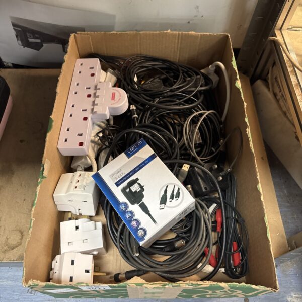 Assorted cables and adapters in a tray, useful electrical connections.