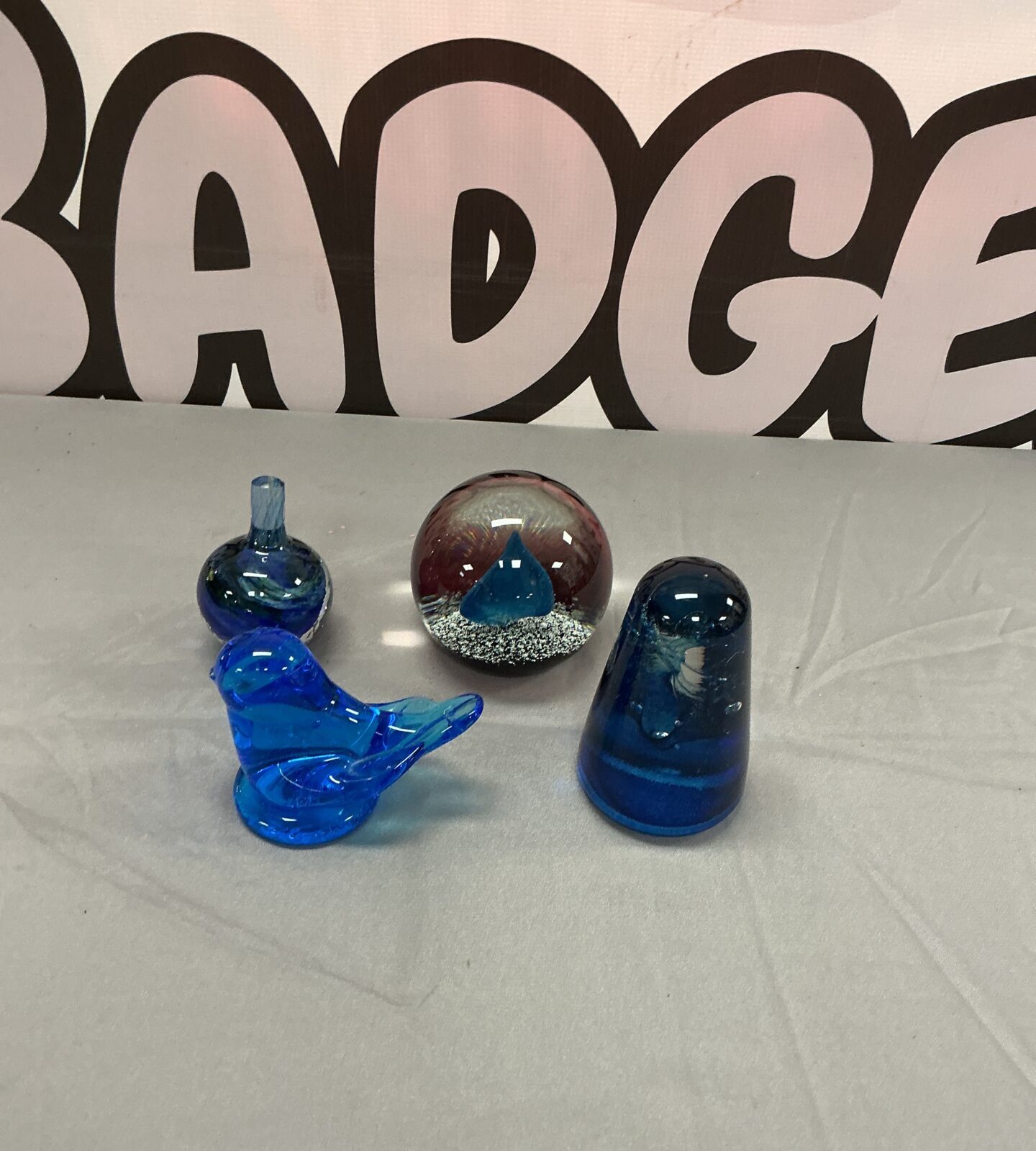 Vibrant blue Caithness paperweight with a bird design inside.