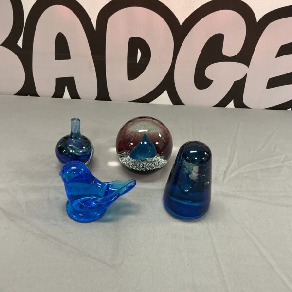 Vibrant blue Caithness paperweight with a bird design inside.