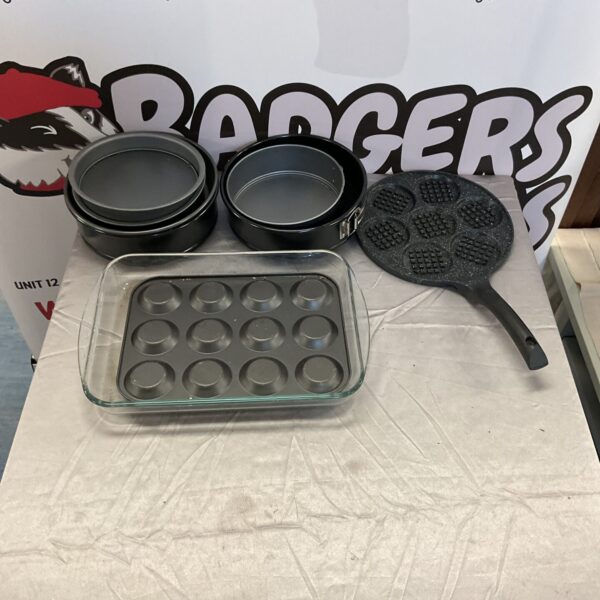 Vintage metal cake tins set including a muffin tray.