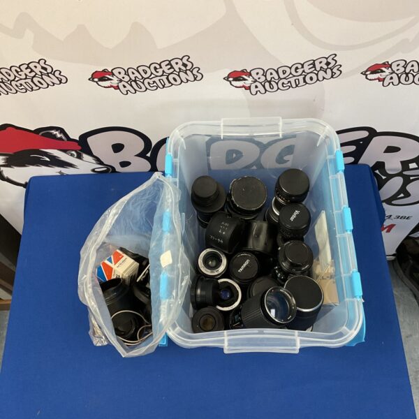 Mixed lot of vintage and modern camera lenses for photography.