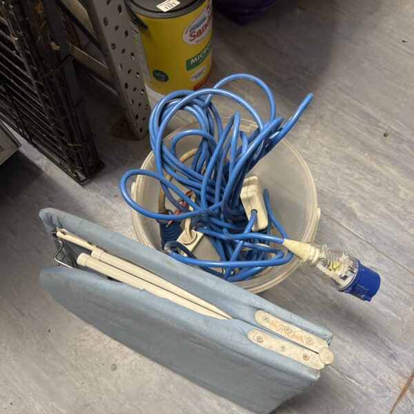 Assorted camping power leads and a folding ironing board for caravans.