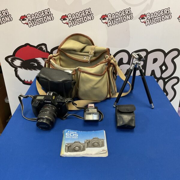 Canon EOS camera with flash and tripod in carry bag.