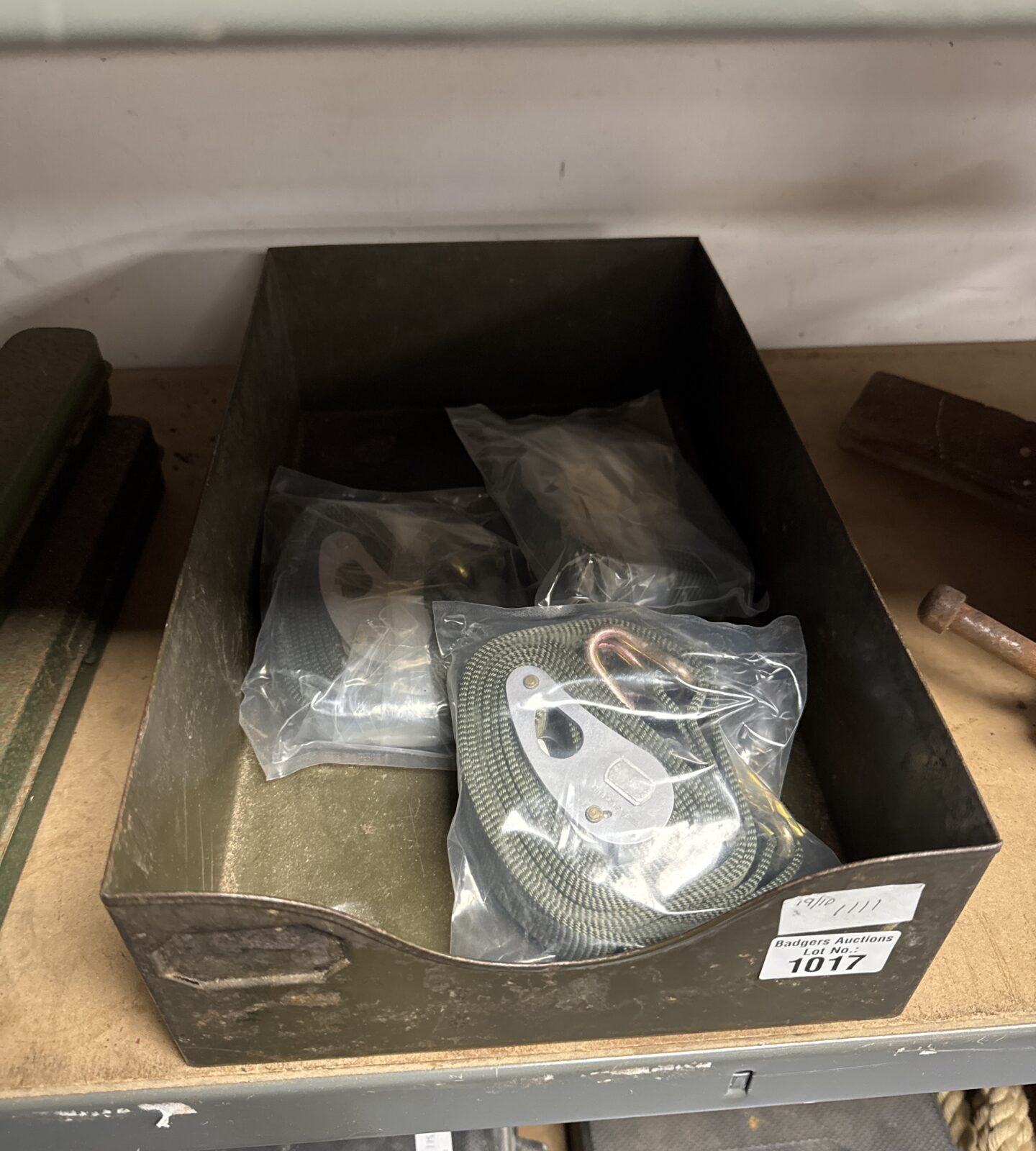 New cargo straps on a metal tray for securing loads.