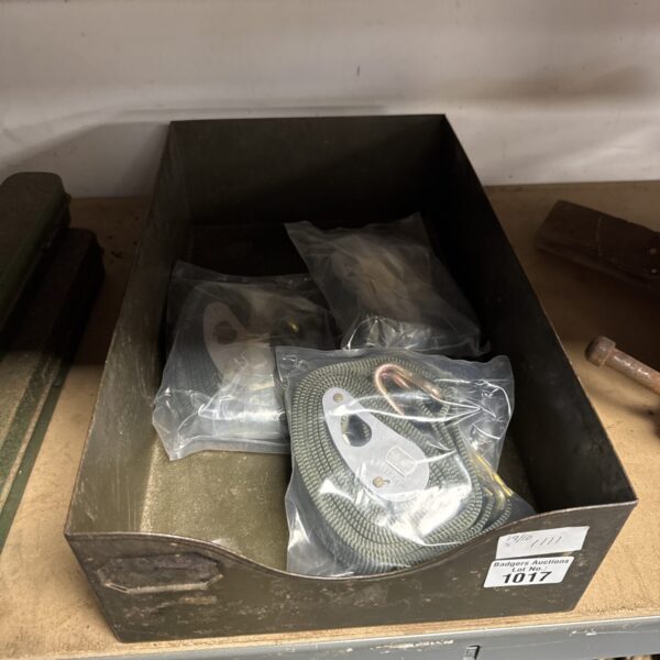 New cargo straps on a metal tray for securing loads.