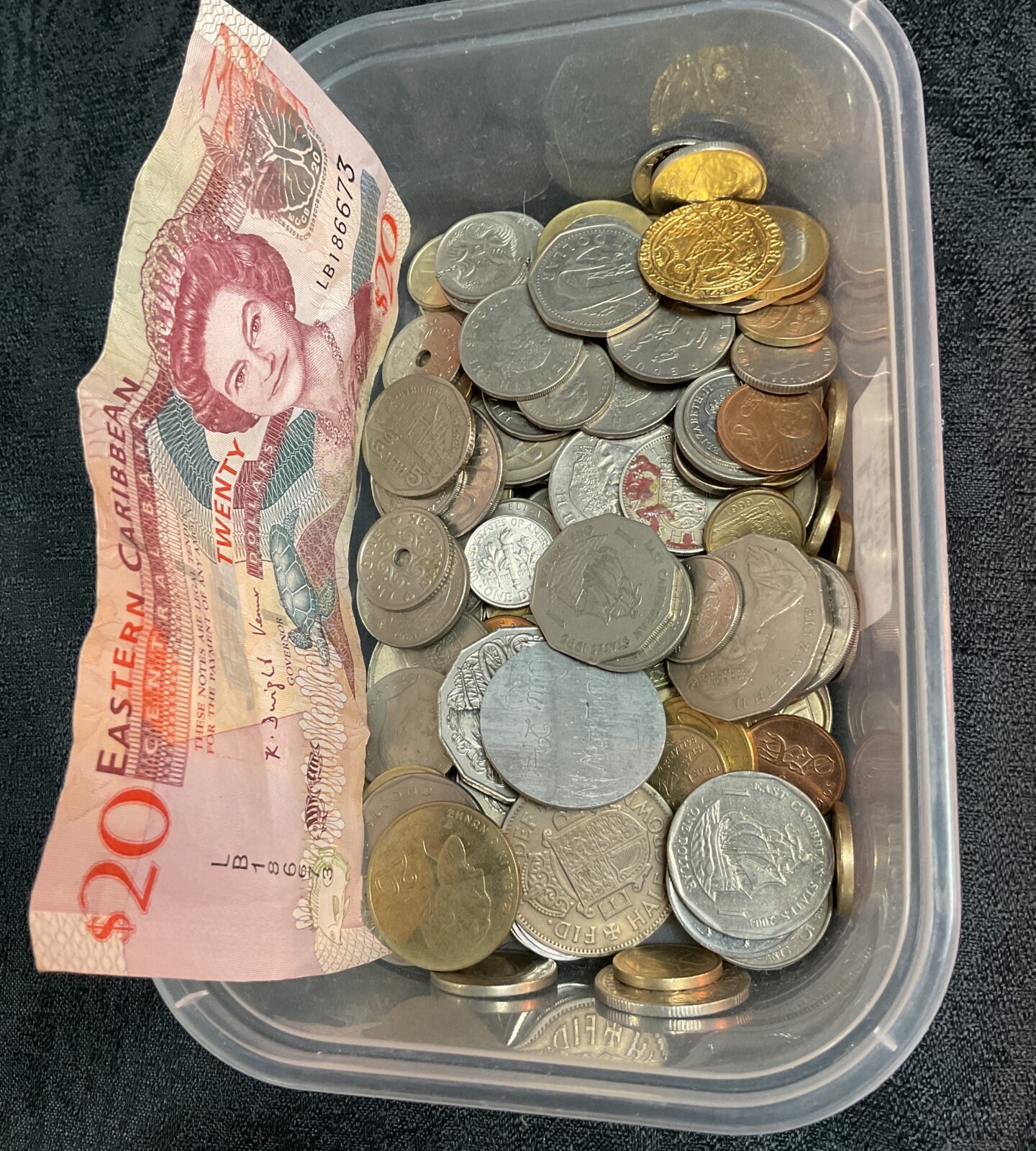 Mixed lot of Caribbean coins and a twenty-dollar banknote for collectors.