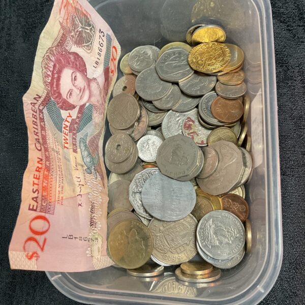 Mixed lot of Caribbean coins and a twenty-dollar banknote for collectors.