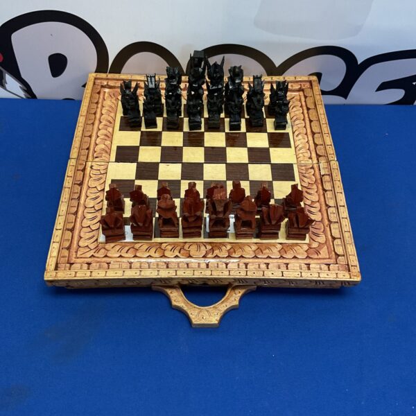 Intricately carved wooden chess set with detailed pieces on board.