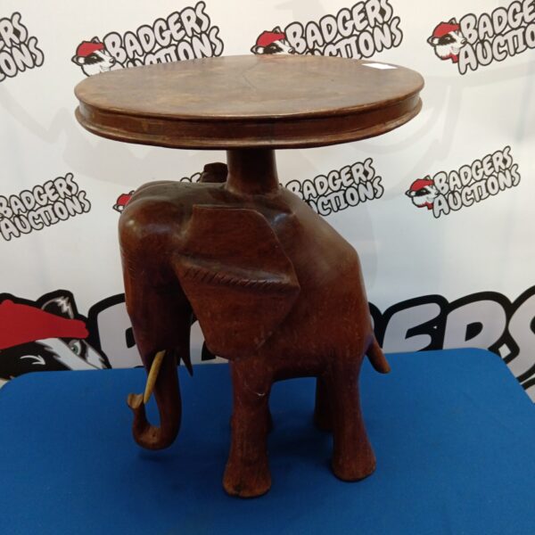Hand-carved wooden elephant table, African art, unique home decor.