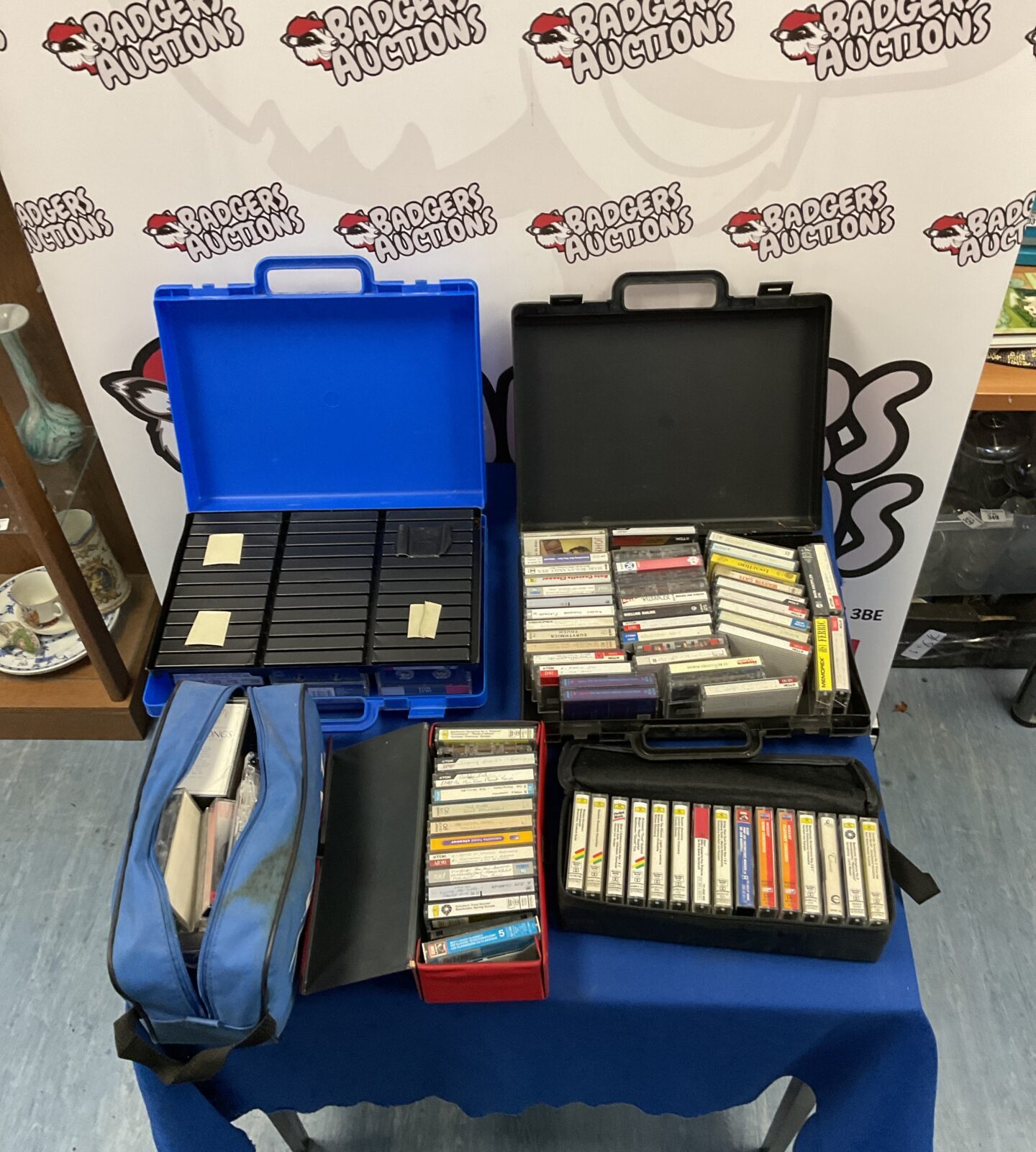 Blue carrying case filled with a large lot of vintage cassette tapes.