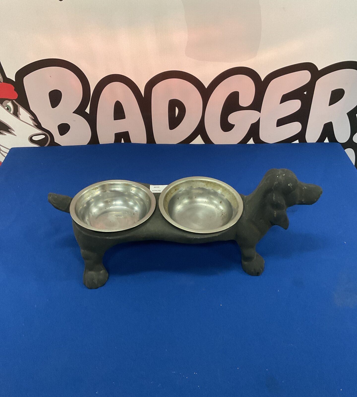 Vintage cast iron dog bowl holder with two bowls.