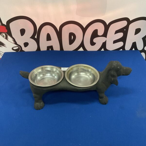 Vintage cast iron dog bowl holder with two bowls.