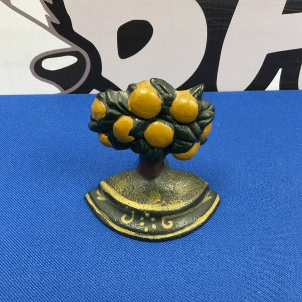 Vintage cast iron lemon tree doorstop for home decor.