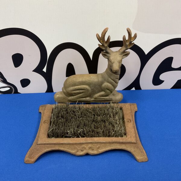 Antique cast iron stag boot brush for cleaning shoes.