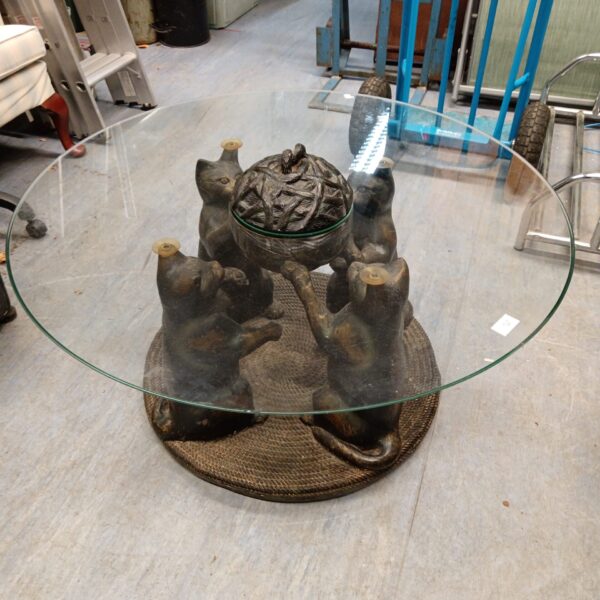 Unique cat table with glass top and detailed feline sculptures.