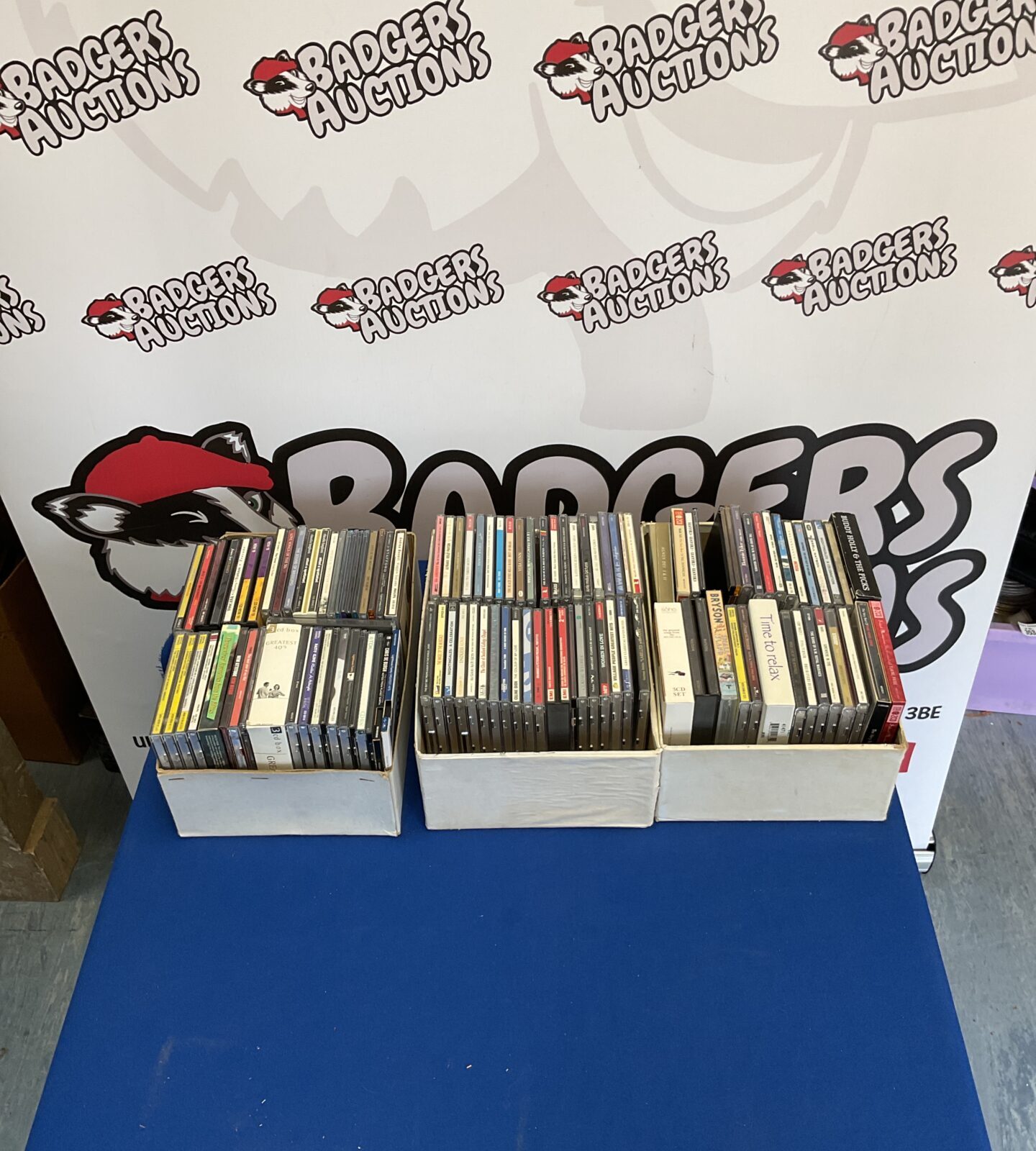 Three boxes filled with a diverse CD collection for music lovers.