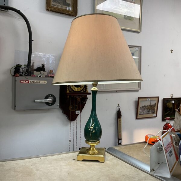 Vintage ceramic table lamp with brass base and cream shade.