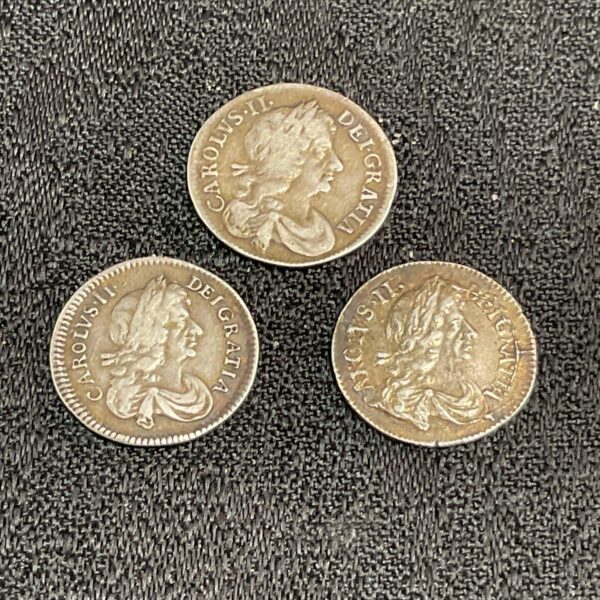 Three silver Charles II Maundy coins from 1673, 1679, and 1680.