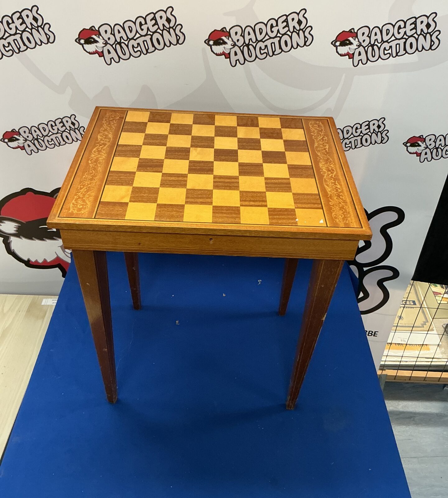 Vintage chessboard table with checkered top and turned legs.