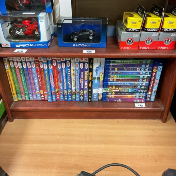 Collection of children’s DVDs and Blu-ray discs in packaging.