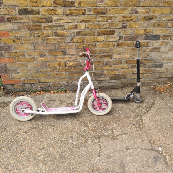 Pearl coloured childrens scooter for outdoor play.