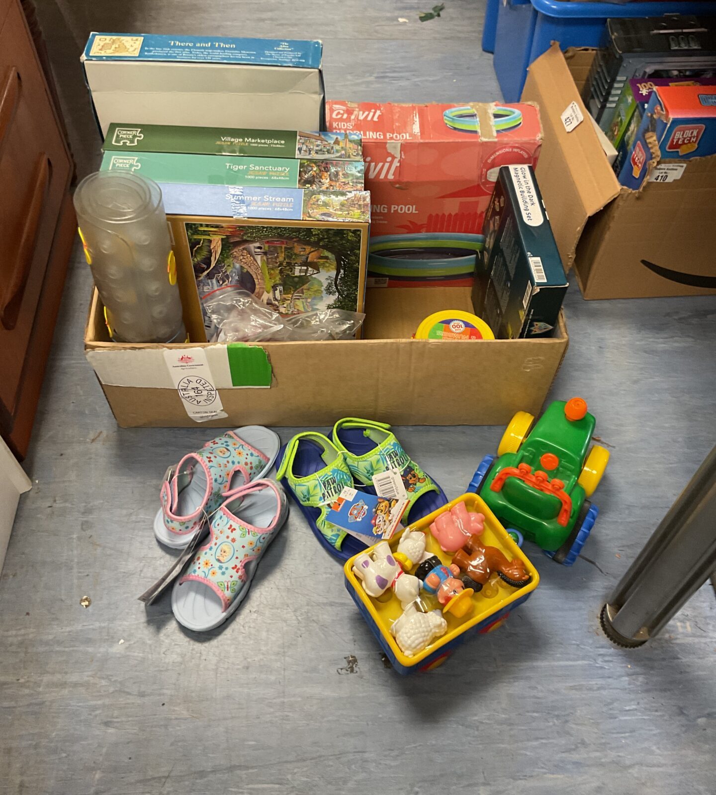 Overview of a childrens toy bundle with sandals and puzzles.