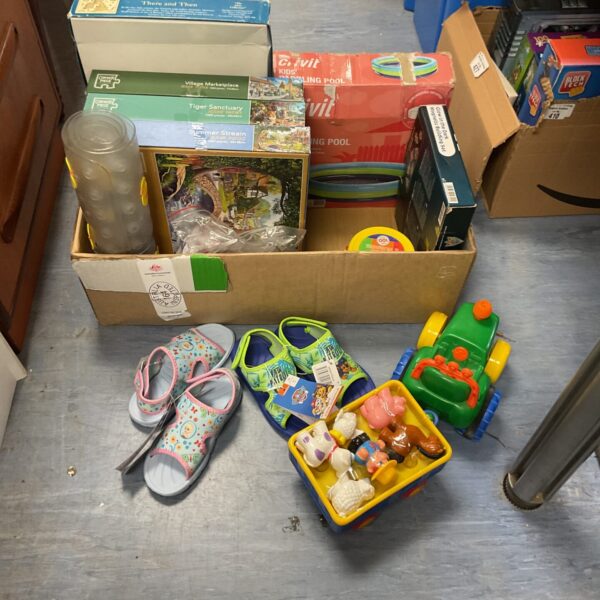 Overview of a childrens toy bundle with sandals and puzzles.