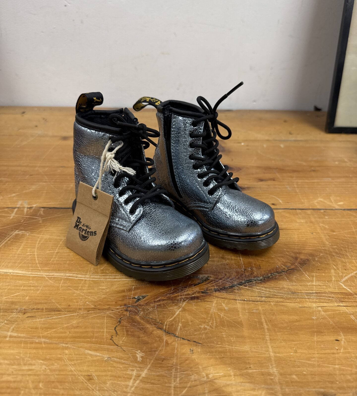 Silver glitter Dr Martens boots for children, side view.
