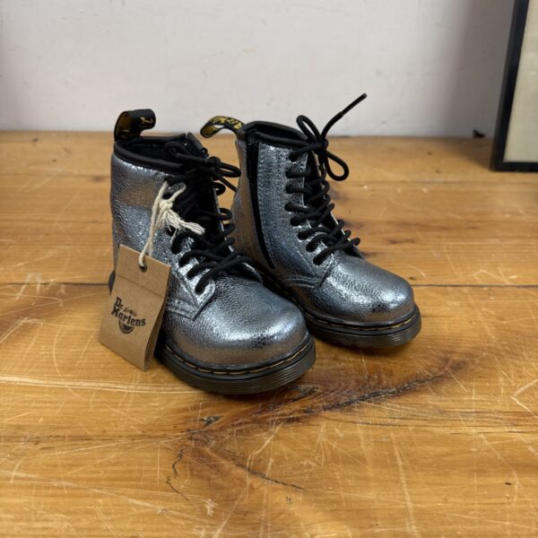 Silver glitter Dr Martens boots for children, side view.