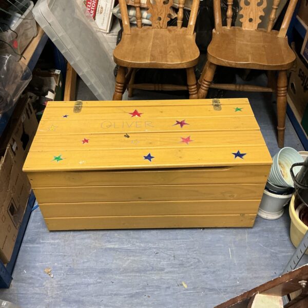Vintage wooden child’s storage chest for toys and nursery decor.