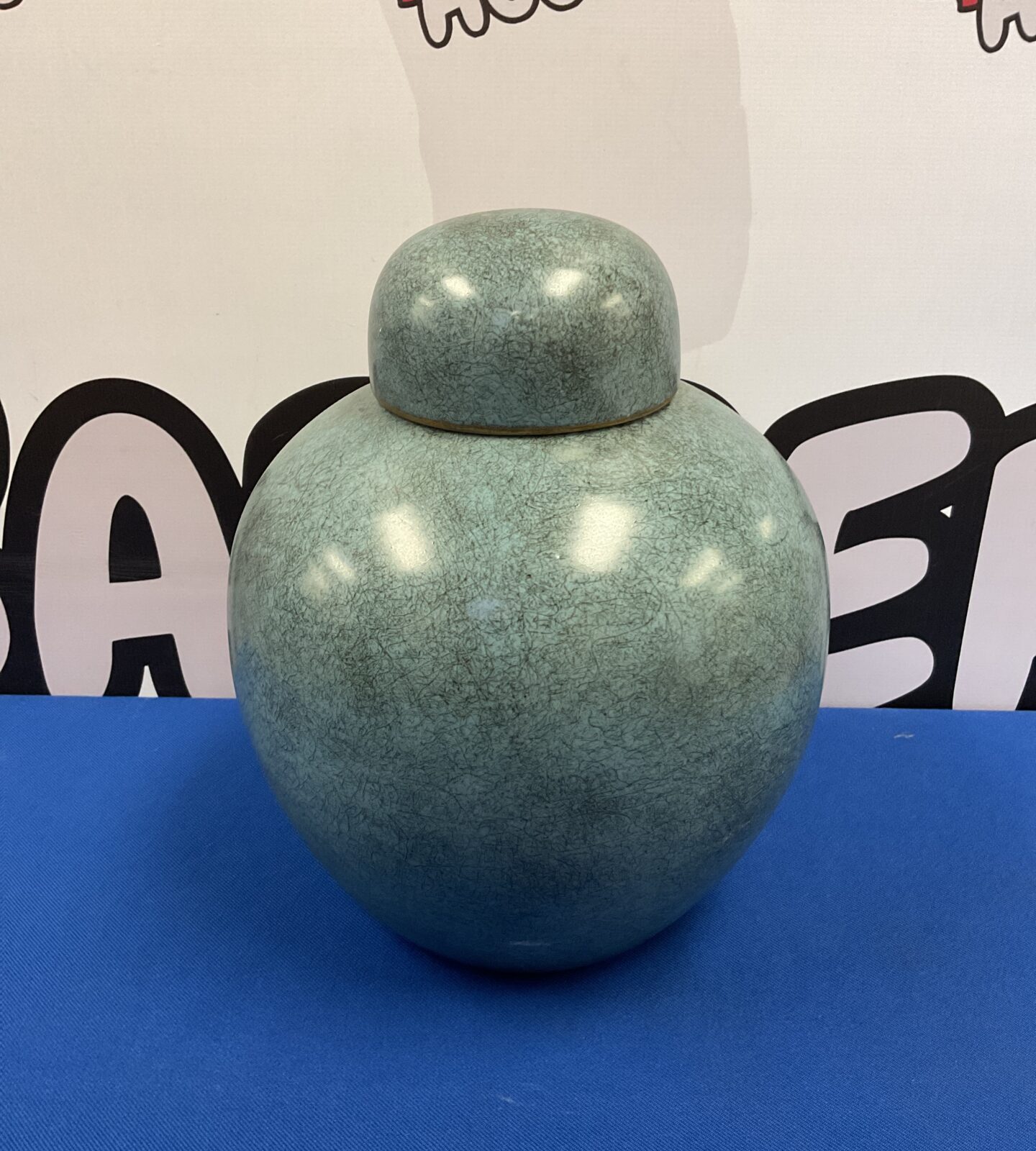 Vintage Chinese lidded pot with speckled green glaze.