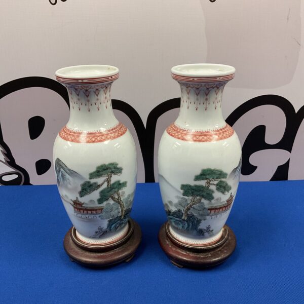 Pair of antique Chinese porcelain vases with hand-painted scenes.